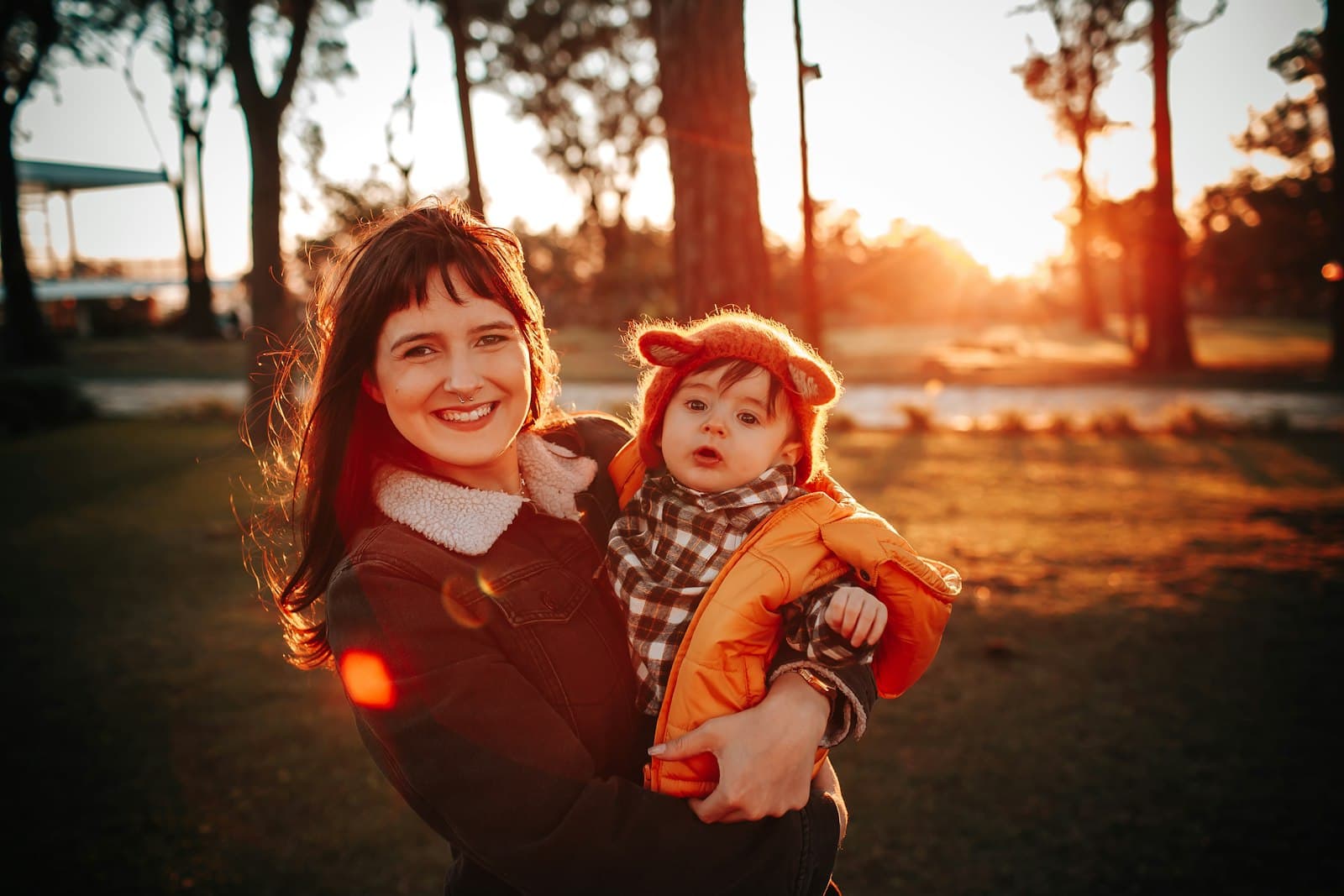 A mother holding her newborn in soft morning light